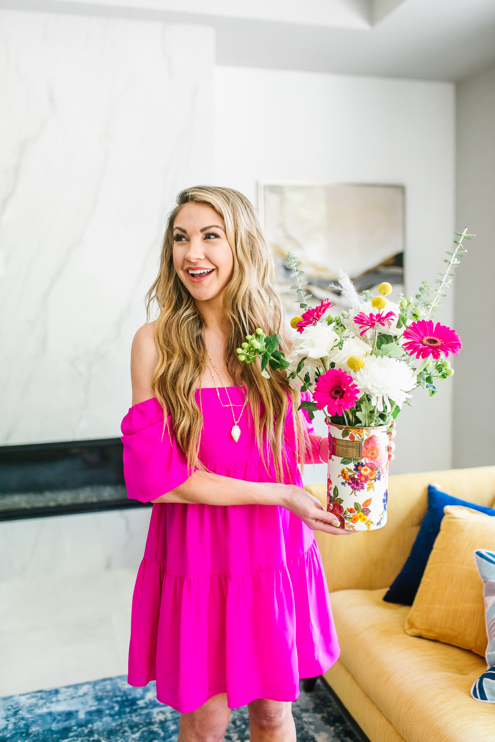 keli in a pink dress holding flowers in a Mackenzie-childs vase